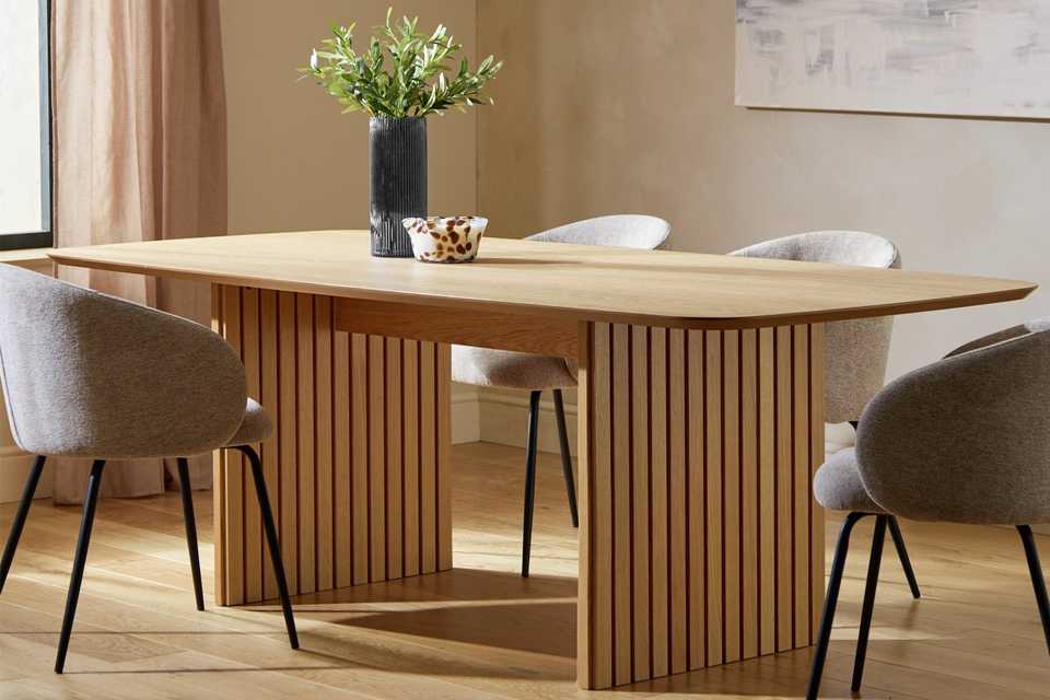 A wooden dining table with four chairs.