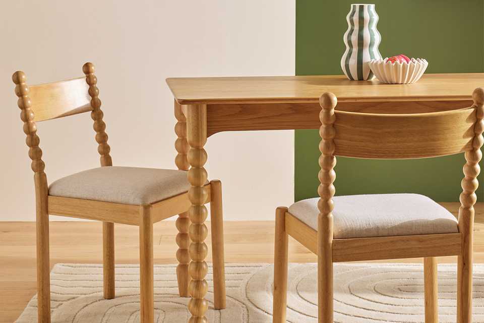 Habitat Blaire Bobbin pair of dining chairs placed with wooden dining table.