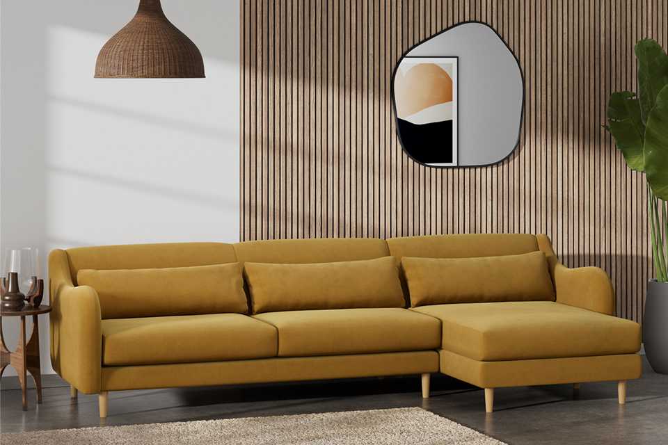 Mustard velvet corner sofa in living room.