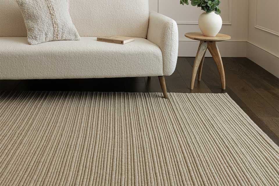 An Asiatic ravine sand wool flatweave rug in a living room.
