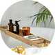 A Habitat bamboo bath bridge with essentials placed over a bathtub.