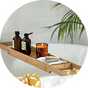 A Habitat bamboo bath bridge with essentials placed over a bathtub.