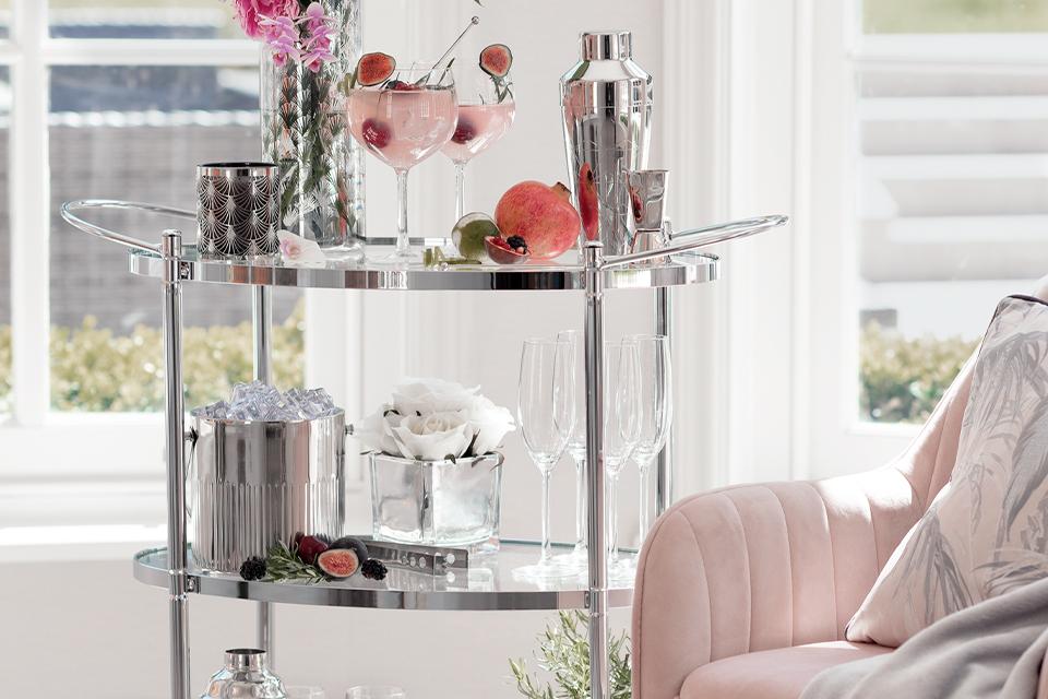 Drinks trolley with glasses and barware.