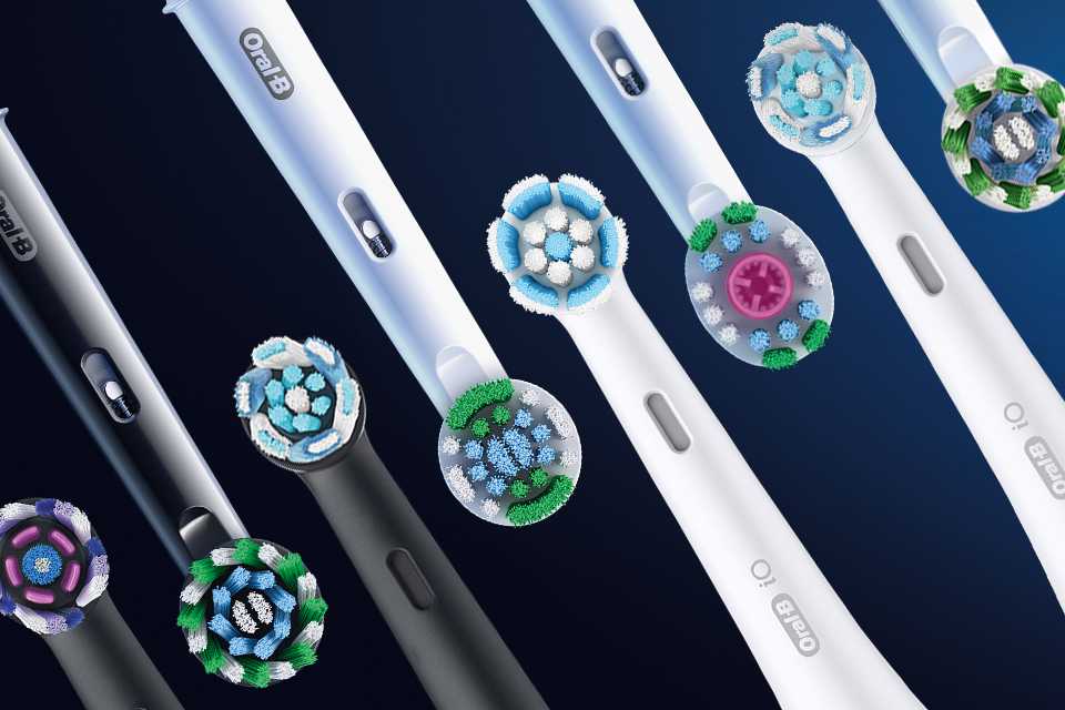 Various coloured Oral-B toothbrush heads displayed next to each other.