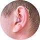 A man with a hearing aid in his ear.