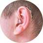 A man with a hearing aid in his ear.