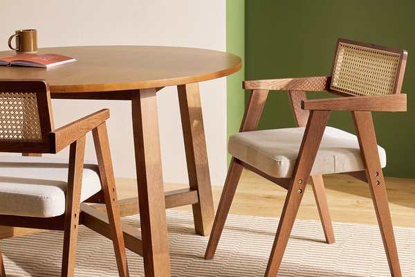 A Habitat cedric pair of solid wood dining chairs in walnut colour.