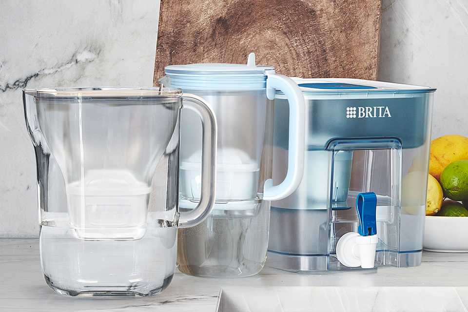 A BRITA Style Essential, Glass Jug & Flow Tank on a kitchen worktop.