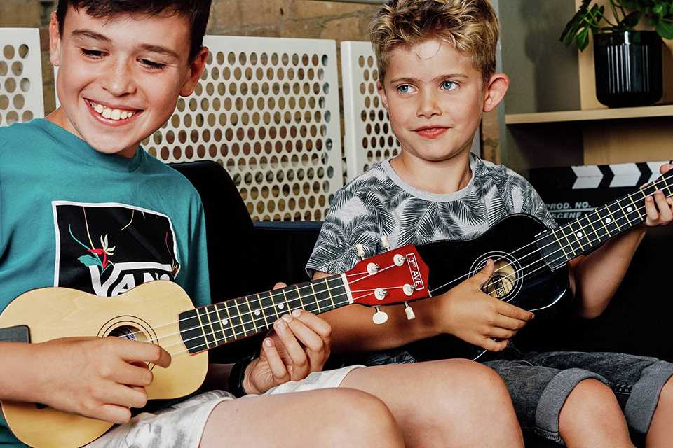 2 kids playing 3rd Avenue Soprano Ukulele.