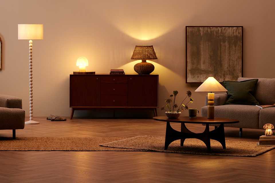 A floor lamp and table lamps creating a warm and inviting environment in a room.