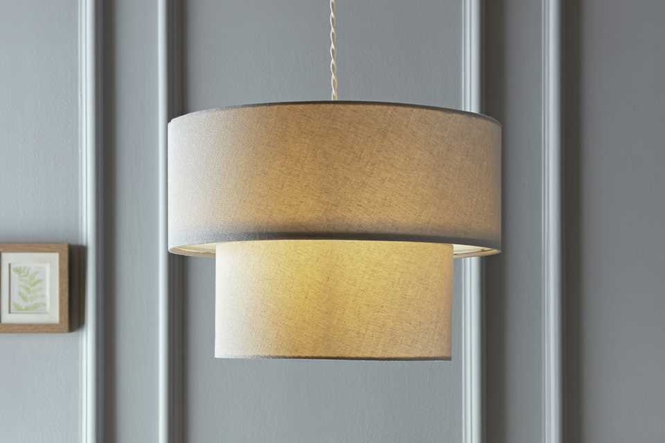 A Habitat grey 2 tier lampshade in a living room.