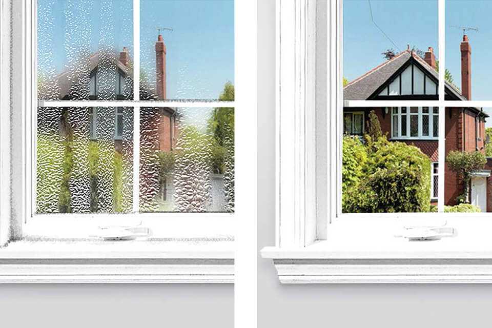 A split image of a window pane that is damp on one side and dry on the other.