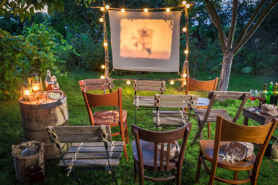 Summer cinema with retro projector in the garden.