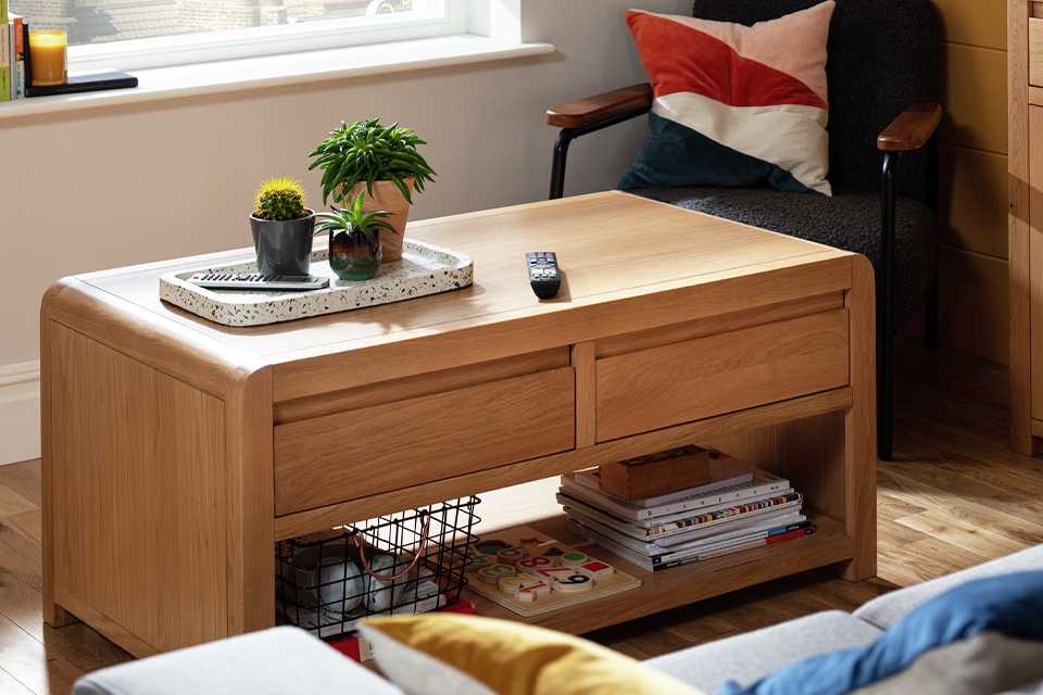 Image of rectangular, wooden coffee table with rounded corners.