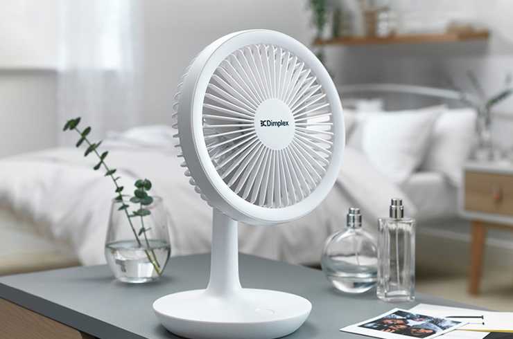 white desk fan on grey table in a bedroom