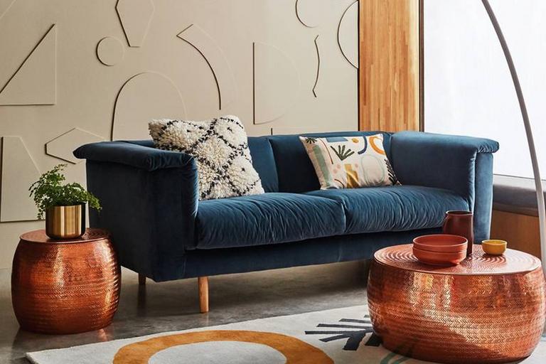 Image of a blue sofa in a living room.