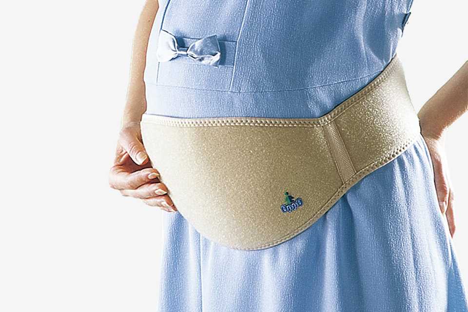 A pregnant woman wearing an OppO Medical Maternity Stress Reliever Belt.