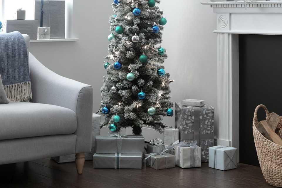 Gift boxes placed under Habitat 6ft Snow Tipped Pencil Christmas Tree.