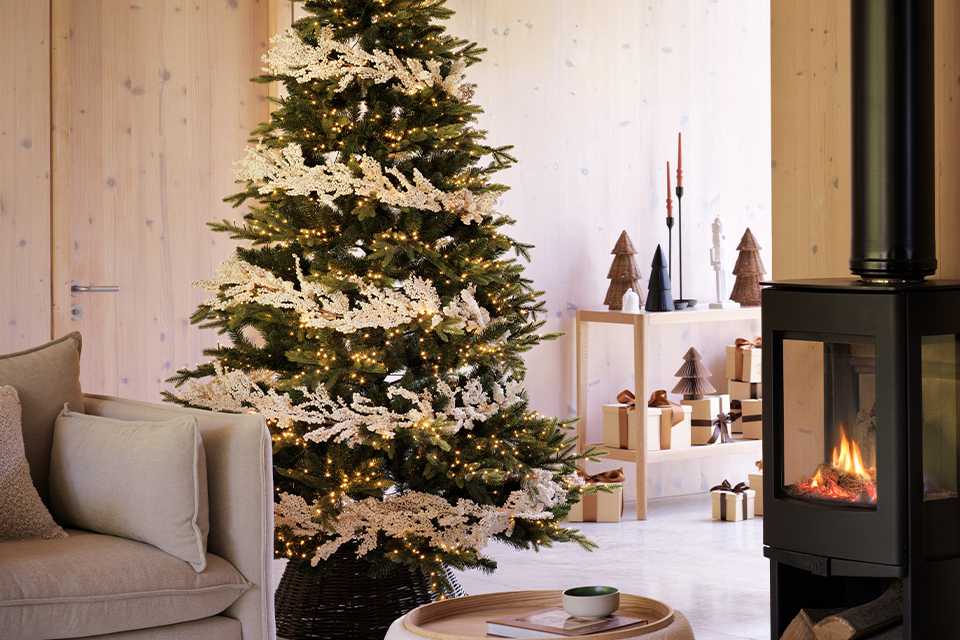 A Christmas tree decorated in silver in a house.