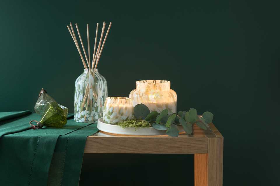 A green diffuser set on a table.