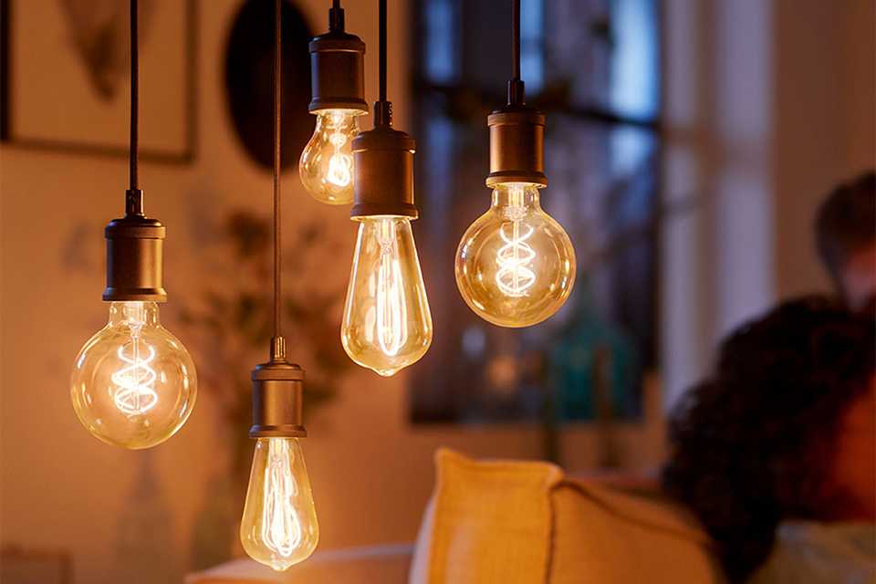 Philips 4W LED ES dimmable light bulbs hanging in a living room setup.