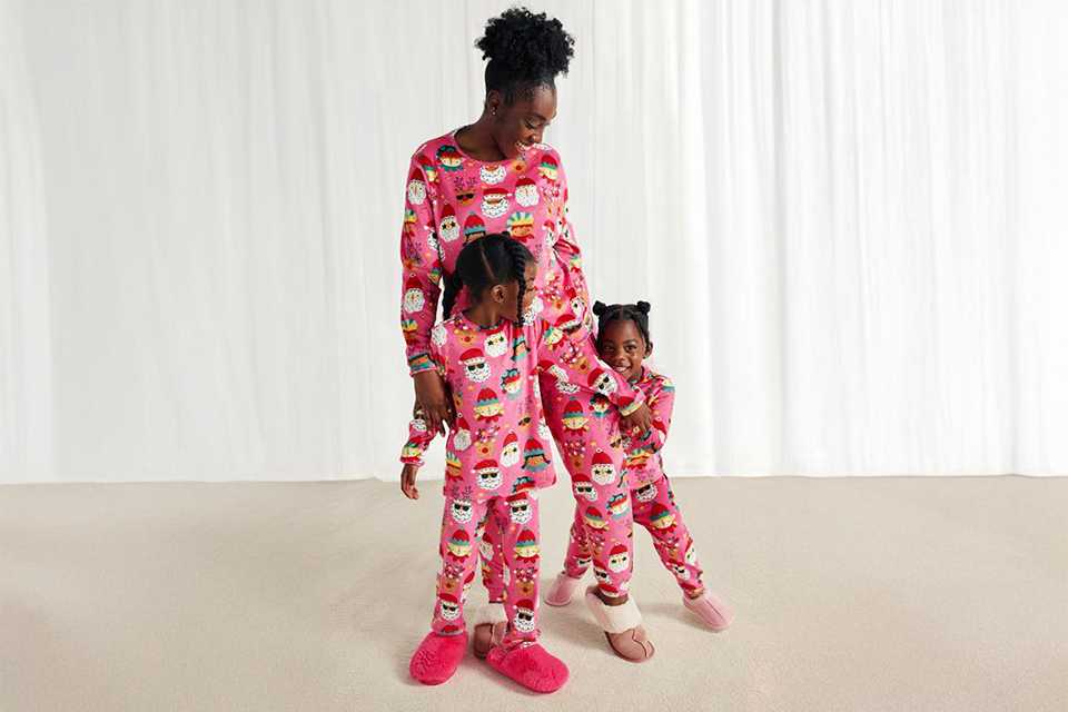 A mother and kids with matching Christmas pyjamas.