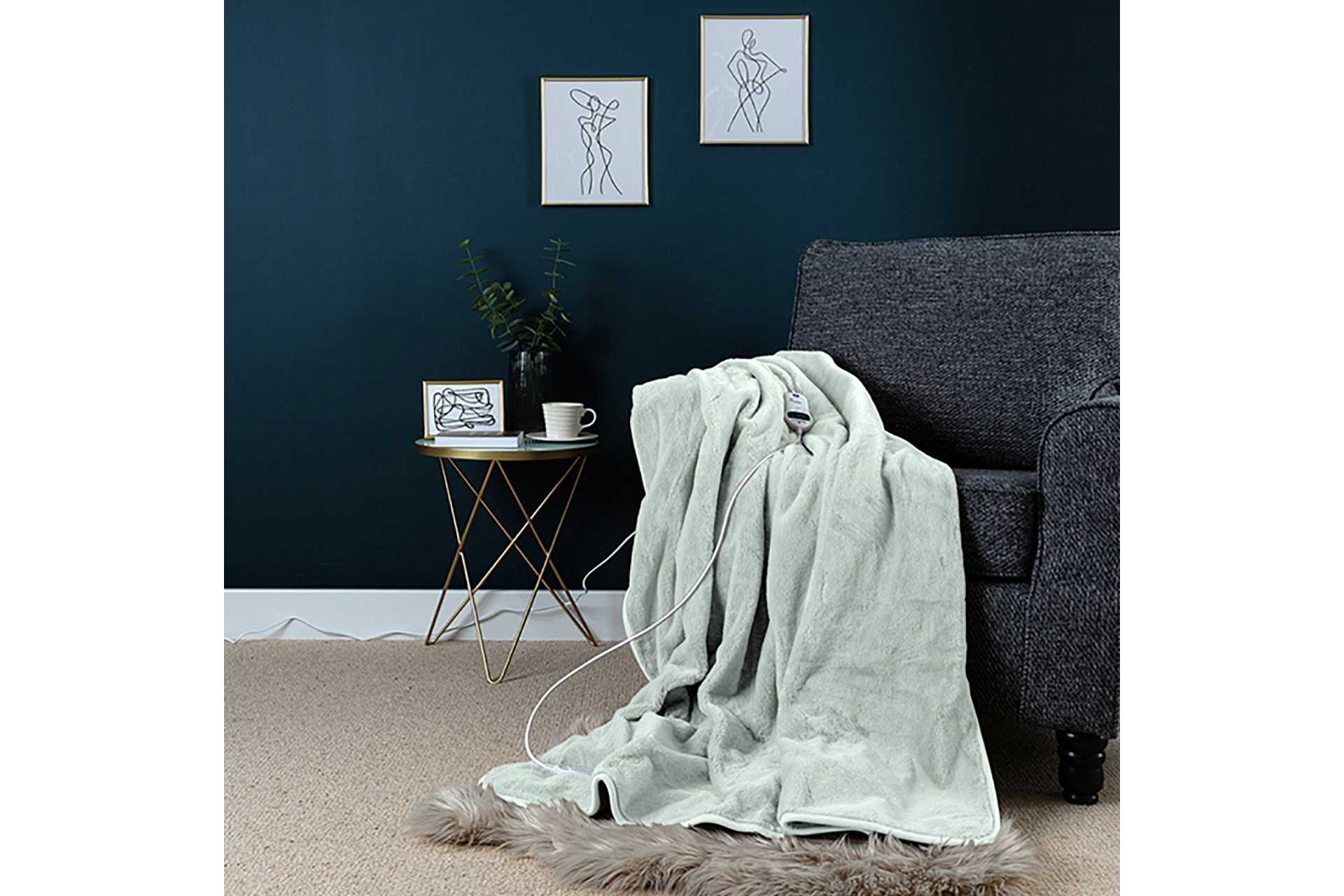 Slumberdown Elegantly Warm luxury heated throw in Pistachio lying on a sofa.