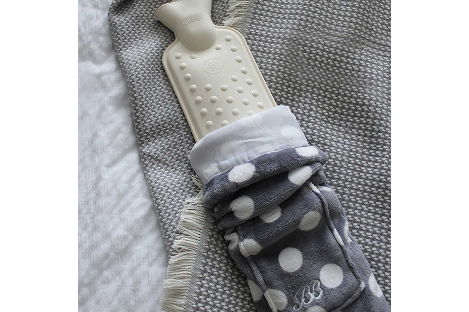 The Body hot water bottle By YUYU in grey polka.