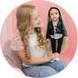 A little girl holding a 46 cm DesignaFriend Connie fashion designer doll.