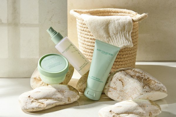 Body Collection Awaken Body Glow Gift Set placed next to a jute basket.