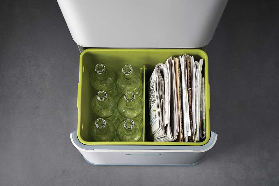 An open recycling bin with compartments for rubbish.