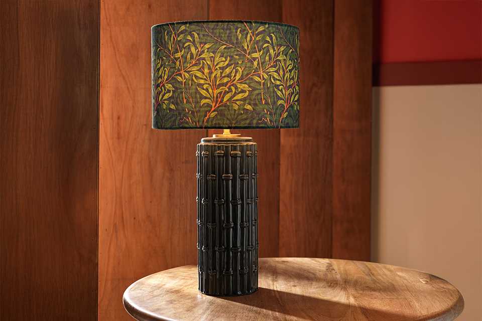 Blackthorne table lamp with embossed base and flroal shade in navy.