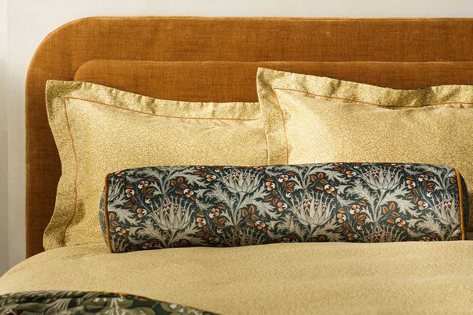 Morris and co. artichoke bolster cushion.