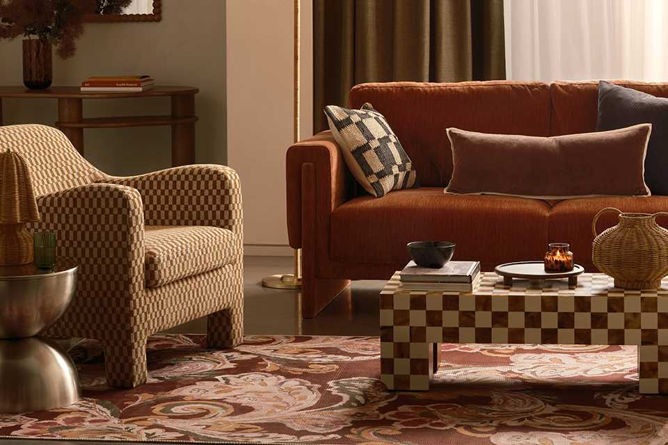 A living room with a patterned coffee table next to a sofa.