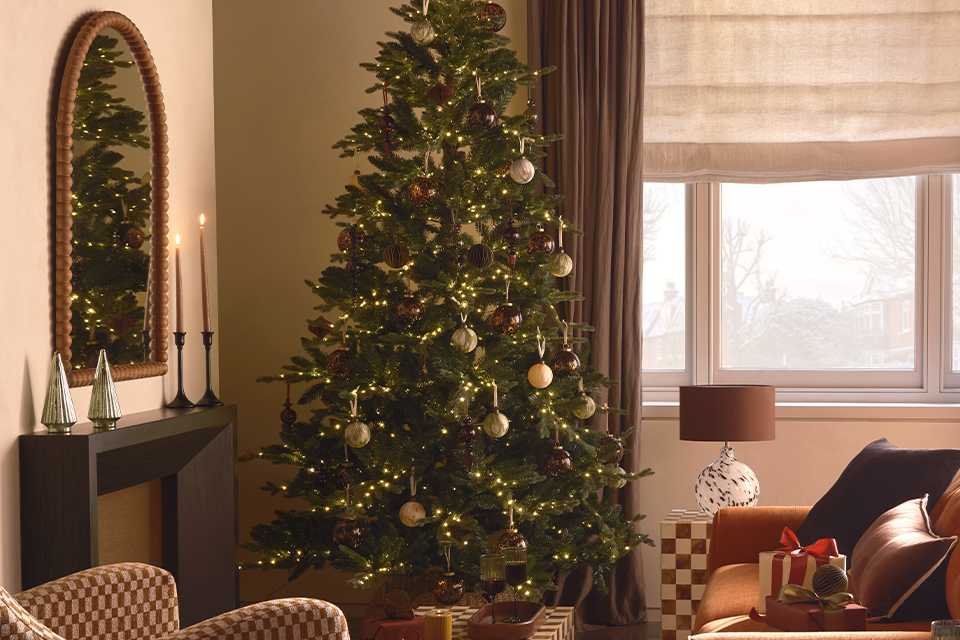 A beautifully decorated Christmas tree in the living room of a house.