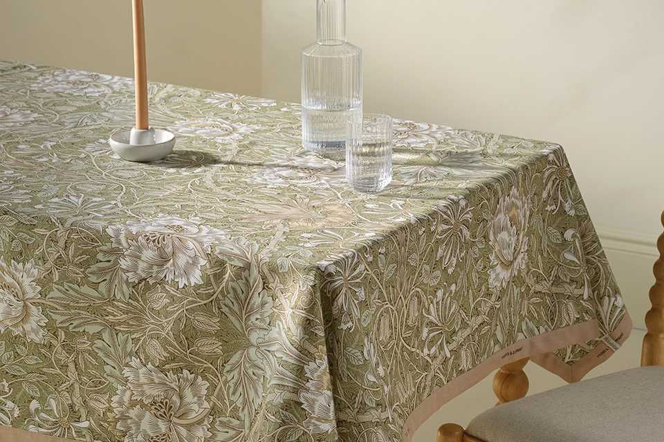 Blue dining room with morris tablware in blue chine floral print and blue tablecloth.