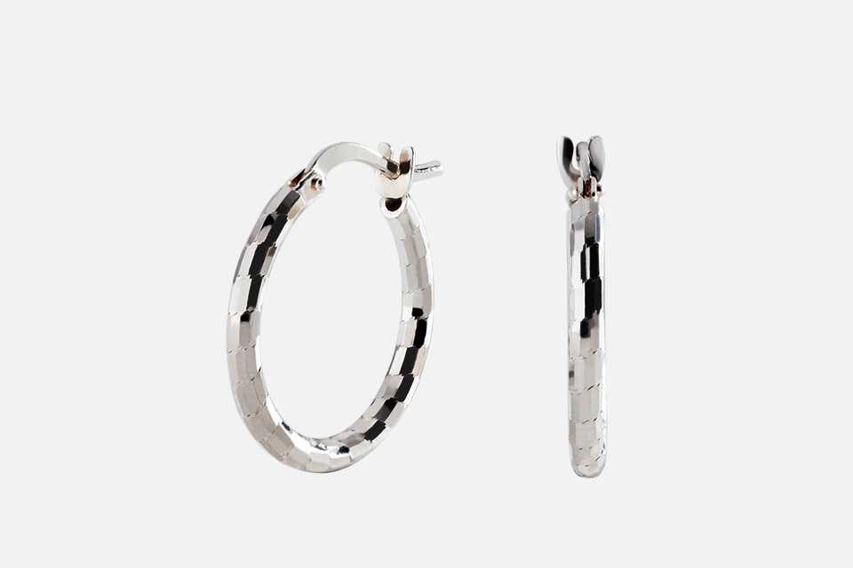 A Revere Italian silver diamond cut hoop earrings.