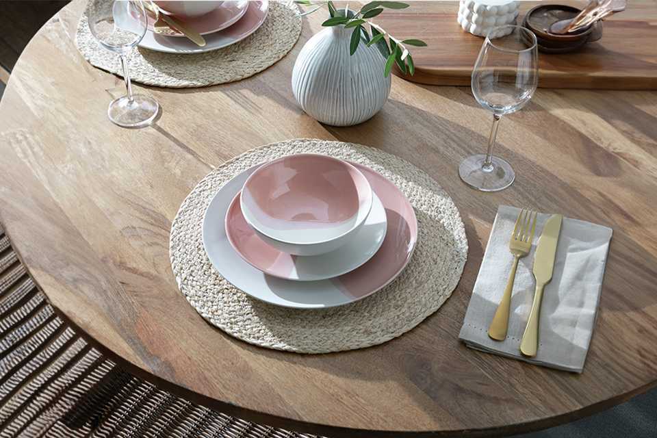 A table set with a Habitat dipped 12 piece multicoloured stoneware dinner set.