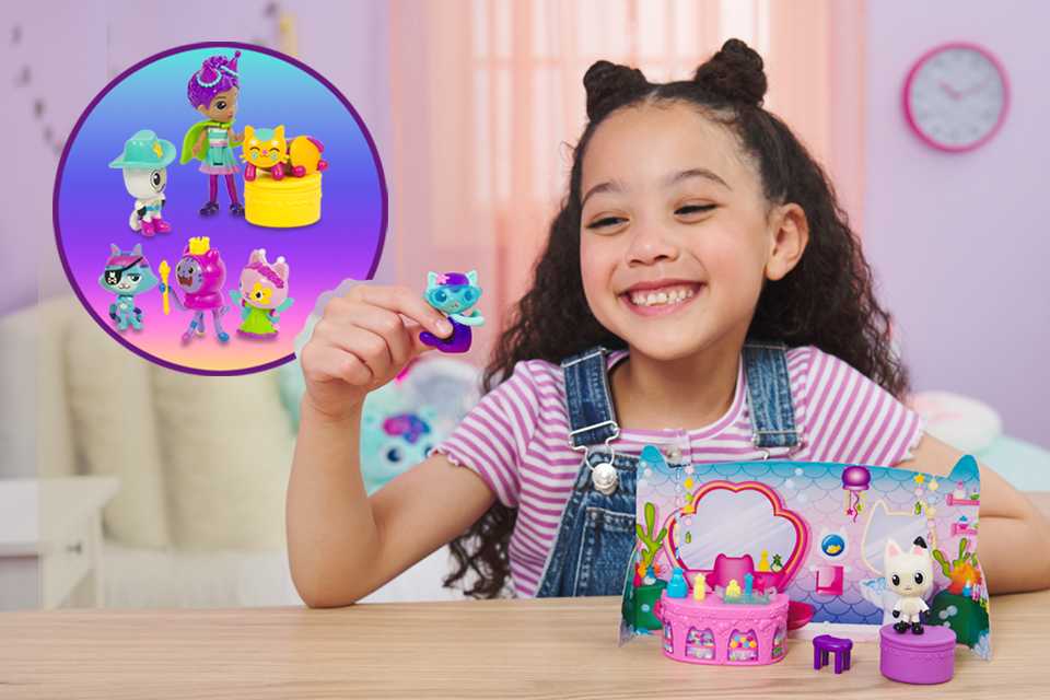 A little girl playing with small Gabby's Dollhouse figures.
