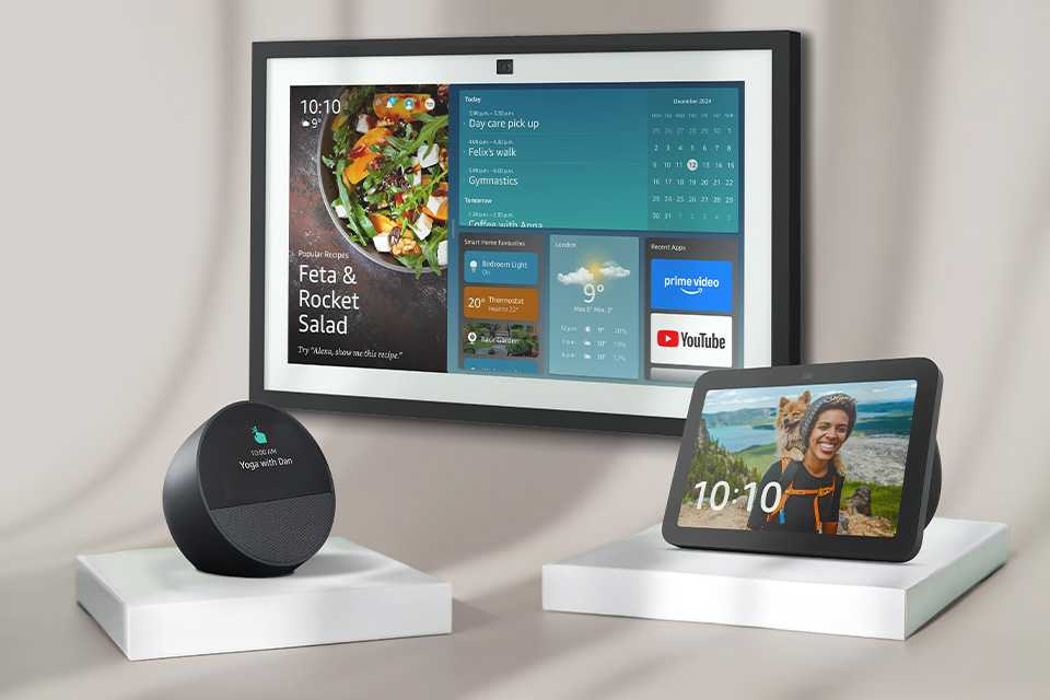 Three Amazon Echo devices with screens displayed against a grey background.