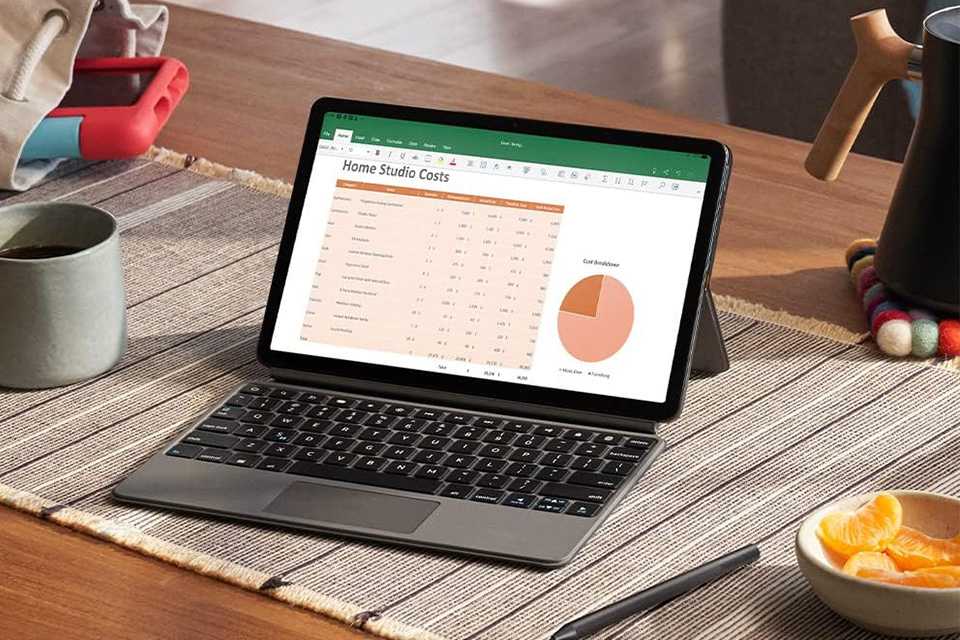 Open screen on a grey Amazon Fire Max 11 tablet placed on a wooden table with other things.