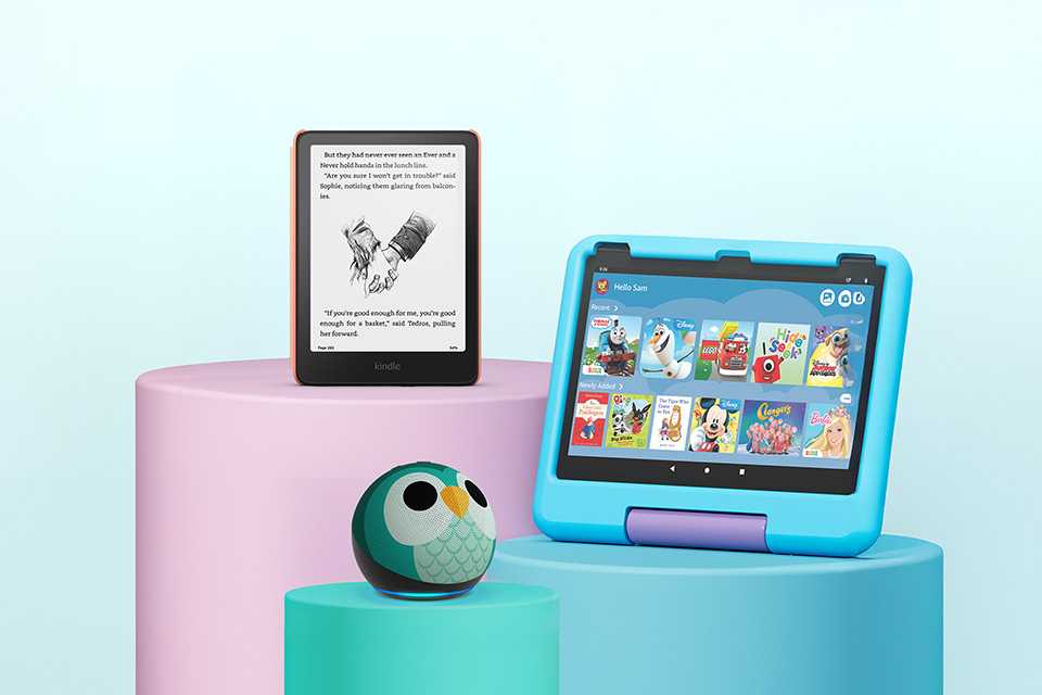 A blue Fire HD kids tablet, green Echo Dot kids smart speaker and a pink Kindle kids e-reader.