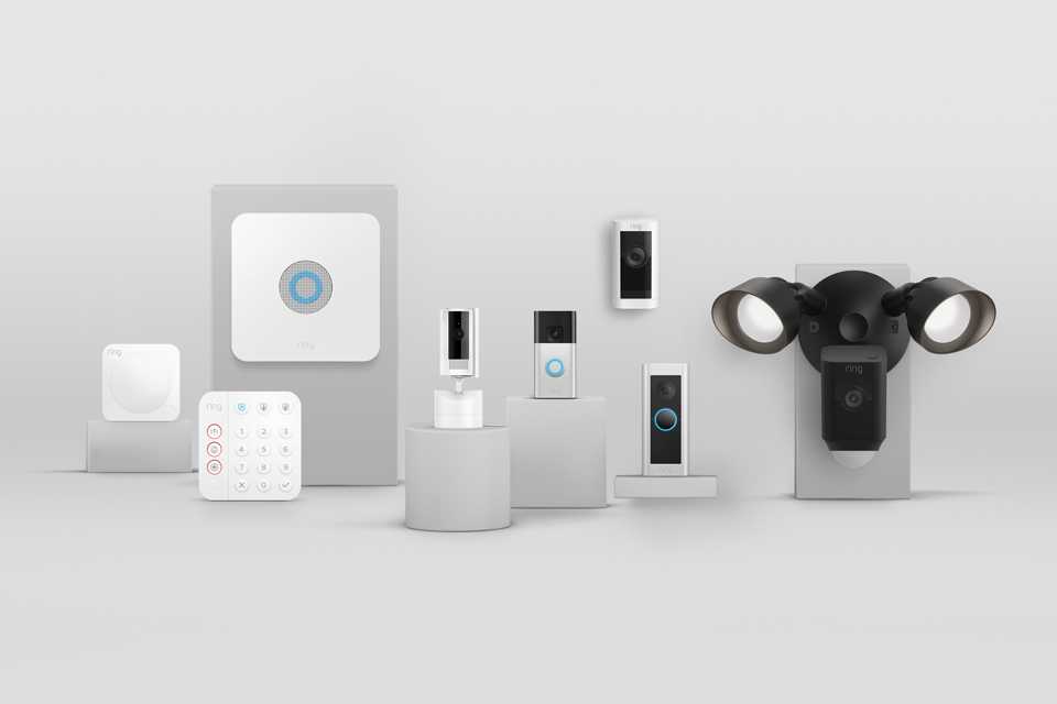 A Ring alarm kit next to various Ring security cameras and video doorbells.