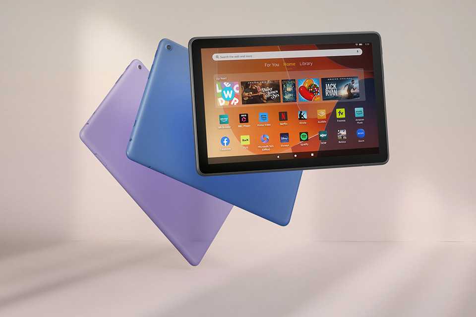 Three Amazon Fire tablets in purple, blue and black against a pinkish grey background.