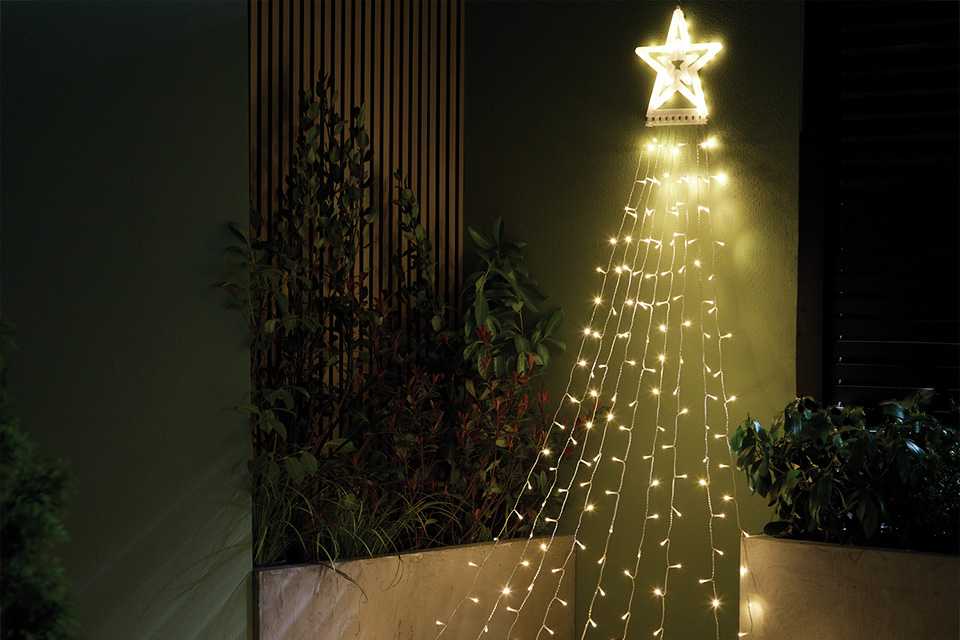 Habitat Warm White LED Light Star Waterfall Decoration in a corner.