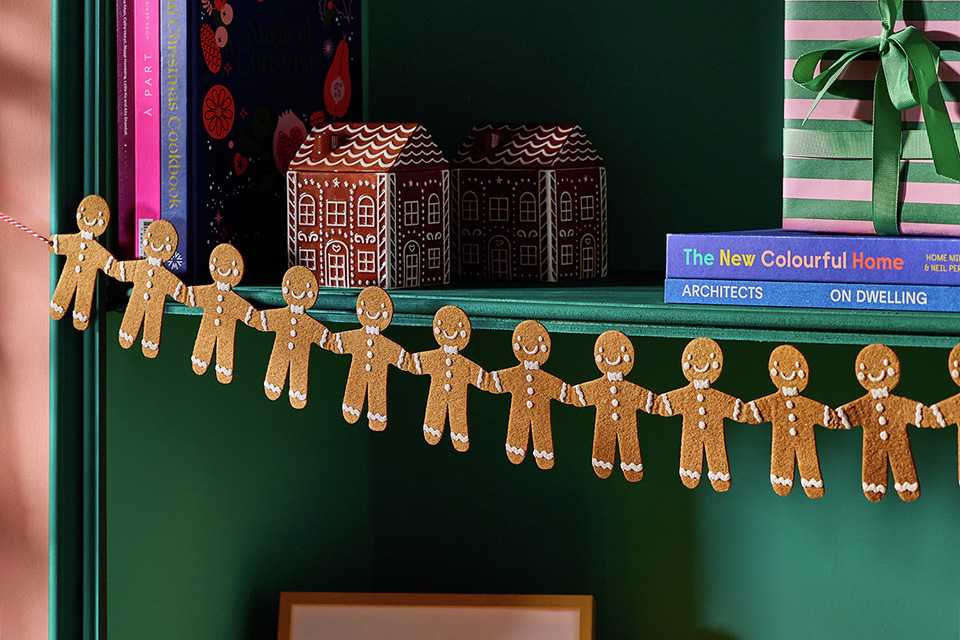 A gingerbread man decoration near a bookshelf in a house.