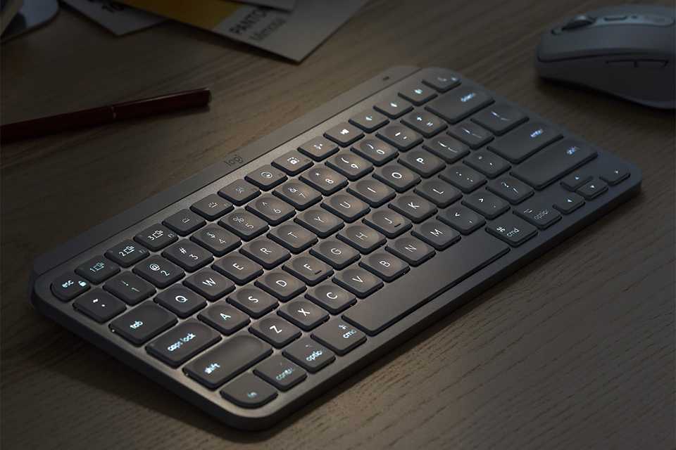 A Logitech mini wireless keyboard next to a mouse on a table.