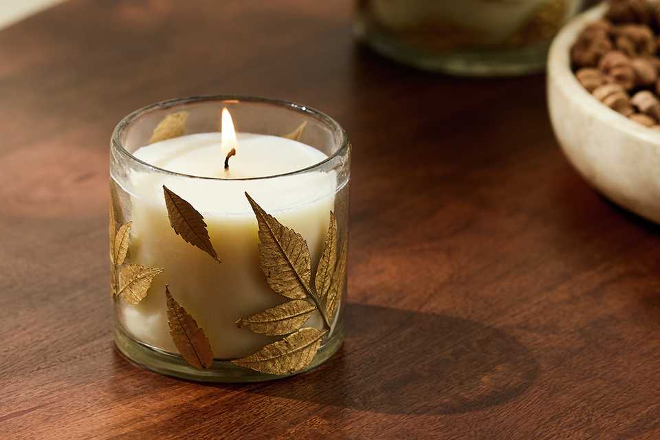 Argos Home floral pressed small glass candles on a table.