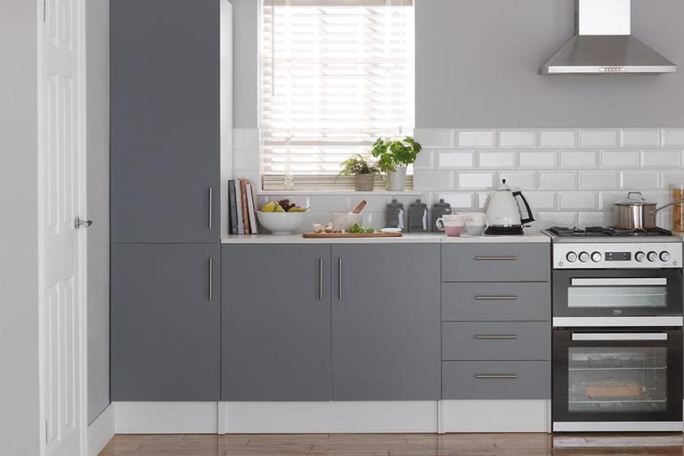 Image of a kitchen fitted with grey kitchen units and accessorised with coordinating modern accessories.