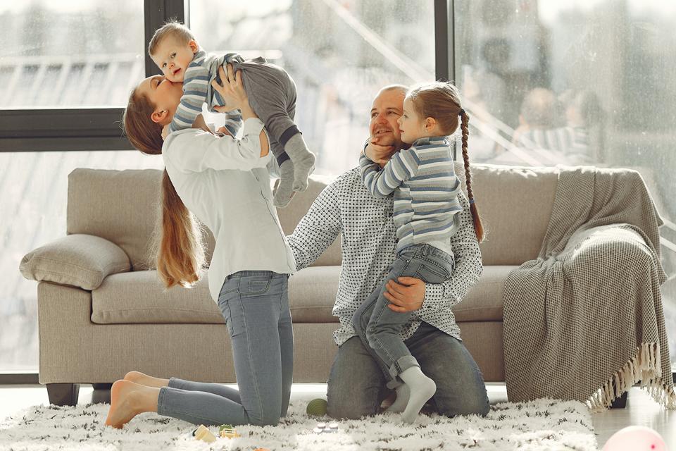 A family playing in the living room.